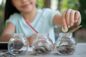 a student saving money in glass jar